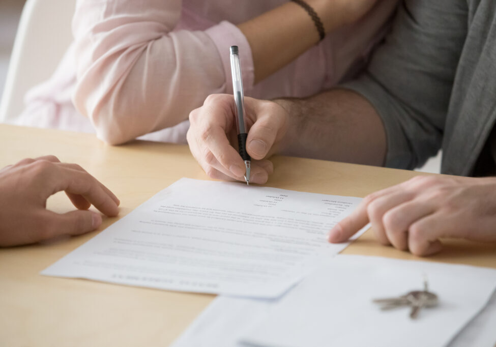 Couple signing rental sale purchase agreement buying renting hou Couple signing rental sale purchase agreement buying renting hou